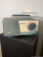 Front of vintage Sony Handy Personal radio showing speaker grille, brand and model name, tuning dial, and control markings.