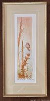 Full view of framed Joan Purcell original colour etching titled 'Spring', showing the bird and plants in warm colors with cream matting and gold frame.