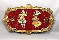 Full view of vintage Italian Baroque Fontanini Depose wall hanging on red velvet background with gold ornate frame