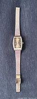 Full length view of the vintage Seiko watch lying flat showing the silver mesh band and rectangular dial.