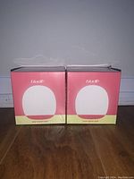 Front view of two unopened GloLife baby night light boxes, showing brand and packaging design.