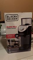 Box of Black+Decker Burr Mill Coffee Grinder showing product image, brand, and grind size settings.
