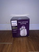 Front of box showing Philips Avent Fast Bottle Warmer branding and image of the product.