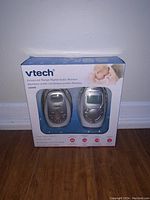 Front of the Vtech baby audio monitor box showing the two units, parent and baby unit, visible through clear packaging.