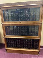 Front view of oak barrister bookcase with three glass-front shelves filled with legal volumes