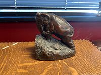 Photo of bronze elephant sculpture on a wooden surface