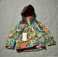 Front view of Burton boys' ski jacket, multicolor print, black hood, orange lining, size 4T tag visible