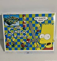 Box front showing colorful Simpsons chess set cover with Bart Simpson holding a sword figure.