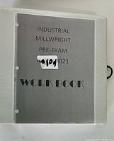 Gray cover workbook titled Industrial Millwright Pre-Exam, with code 9101 1021 and WORK BOOK text.