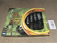 Original box of Lord of the Rings Fellowship of the Ring Chess Set showing some silver pieces in display window and branded packaging