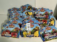 Photo showing 20 sealed Mighty Express toy trains in packaging, featuring Freight Nate, Build-It Brock, and Rescuer Red models.