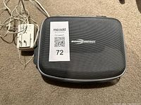 Zippered black carrying case with Sonic Impact logo on top.