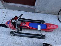 Photo showing entire Spider-Man sled with its structure, skis, and seat.