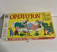 Front view of the vintage Operation game box featuring colorful cartoon medical illustration and yellow background.