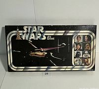 Front view of the vintage Star Wars board game box showing the title, a spacecraft, and several character images.