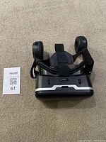 Front and top view of VR Shinecon headset showing adjustable straps and cushioned eyepieces.