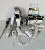 Overview of Nintendo Wii console and accessories, remotes, sensor bar, cables, attachments and game cases