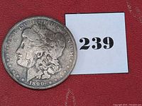 Obverse side of the 1890-O Morgan Silver Dollar showing Lady Liberty's profile with visible wear.