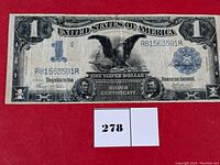 Full front view of 1899 Black Eagle Silver Certificate on red background