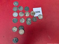 Full layout of 18 Seated Liberty dimes on red background, showing size, shape, and patina variance, some coins darker and coins spaced irregularly.