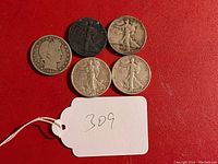 Top view of all five coins on red background with lot tag '309'. Includes one Barber half dollar and four Walking Liberty half dollars.