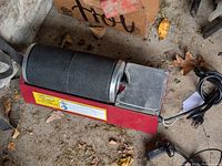 Full view of Chicago Electric Double Drum Rotary Rock Tumbler showing two black textured barrels side by side on a red base with a power cord.