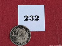 Obverse view of heavily worn 1896 Barber Quarter along with lot number label 232.