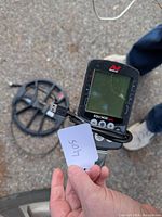 Minelab Equinox 800 control unit and USB cable in hand, separate search coil visible