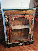 Full front view of cabinet showing Boulle marquetry panels, glass top, gilt bronze mounts