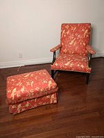 Arm chair and footrest shown together from front angle on hardwood floor.