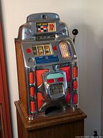 Full front and side view showing wooden base and chrome shell with red highlights