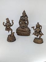 Front view of all three bronze Hindu deity statues on white background
