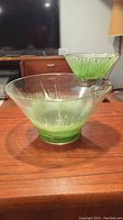 Two-piece chip and dip set in green tinted glass featuring atomic starburst pattern. Larger bowl approx 10.5 inches wide by 9 inches high. No marks or chips visible, needs washing.