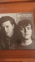 Front cover of Tears for Fears Songs From The Big Chair vinyl record featuring two band members in black and white.