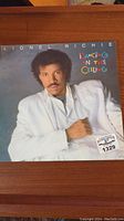 Front cover of the Lionel Richie album 'Dancing in the Ceiling' featuring a photo of Richie in a white jacket.