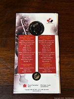 Front of sealed package showing silver dollar coin and collector pin with informational text about composition, dimensions, and commemorative significance.