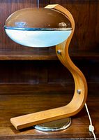 Front and side view of bi-colour acrylic flying saucer shade with teak bentwood curved frame and round metal base