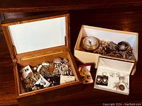 Wooden box and smaller container filled with assorted estate jewelry including necklaces, chains, brooches, earrings and a clock