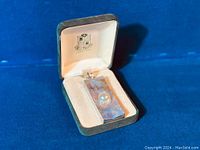 Sterling silver bar pendant with central Mabe pearl inset in lined jewelry box.