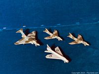 Four diecast military jet planes with RAF insignia on a blue background