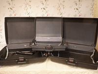 Open view of three Samsonite Oyster GLS hard-sided suitcases showing interiors with combination lock spring handles and side locking handles.