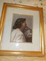 Full view of the framed gazing lady print showing gold beveled frame and double ivory mat with gold pencil edging.
