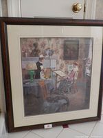 Framed Victorian drawing room print showing the full artwork and surrounding double mat, set against a door.