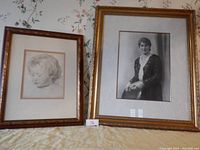 Overall view of two framed portrait pictures: child drawing on left, woman photo on right