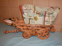 Side view of the vintage wooden wagon lamp with fabric nautical design cover and wooden wheels.