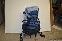 Front view of blue Tatonka travel backpack showing main compartments and straps