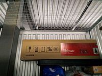 Side view of the long rectangular box showing brand label and handling icons