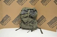 Front view of the green Mountain Warehouse travel bag showing the main compartment, drawstring closure and securing straps.