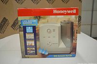 Photo of the original box showing the Honeywell humidifier with key features highlighted on the package.