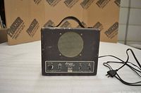 Front view of the Lektro Tuner showing speaker, controls, and power cord.